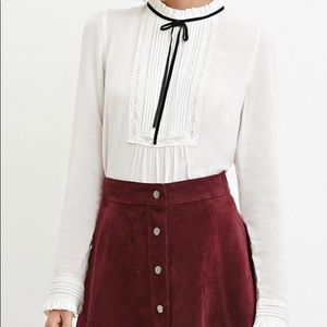 White & Black long sleeve, tie neck blouse.